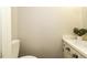 Bright half-bath featuring patterned wallpaper, a vanity, and a toilet at 104 Province Cir, Rocky Mount, NC 27804