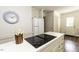 This well-lit kitchen offers a cooktop stove, white cabinets, and a modern clock at 104 Province Cir, Rocky Mount, NC 27804