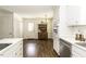 Open kitchen showcasing hardwood floors with white cabinets and stainless steel appliances at 104 Province Cir, Rocky Mount, NC 27804