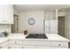 The kitchen boasts white cabinets, solid countertops, a cooktop stove, and a modern clock at 104 Province Cir, Rocky Mount, NC 27804
