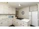 Cozy kitchen features white cabinetry, solid countertops, and a smooth cooktop stove at 104 Province Cir, Rocky Mount, NC 27804