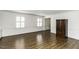 Open living area with hardwood floors, large windows, and an armoire at 104 Province Cir, Rocky Mount, NC 27804