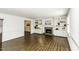 Spacious living room with built-in shelving, a brick fireplace, and beautiful hardwood floors at 104 Province Cir, Rocky Mount, NC 27804