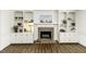 Cozy living room featuring a brick fireplace with built-in cabinets and hardwood floors at 104 Province Cir, Rocky Mount, NC 27804