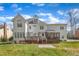 Rear exterior view showcasing a well-maintained home with a deck, screened porch, and landscaped yard at 106 Legault Dr, Cary, NC 27513