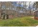 Landscaped backyard features a lawn, trees, and an arbor with access to a screened-in back porch at 106 Legault Dr, Cary, NC 27513