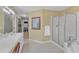Bright bathroom features a shower with glass enclosure, and a spacious white vanity, and tiled floors at 106 Legault Dr, Cary, NC 27513