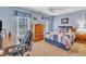 Nautical themed bedroom with blue walls, featuring a ceiling fan, and a cozy bed with a decorative headboard at 106 Legault Dr, Cary, NC 27513