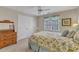Comfortable bedroom featuring neutral walls, double closet, ceiling fan and a floral-themed bedspread at 106 Legault Dr, Cary, NC 27513