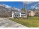 Two-story home with a beautiful lawn, mature trees, and a long paved driveway at 106 Legault Dr, Cary, NC 27513