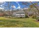 Charming two-story home with classic black shutters, beautiful landscaping, and a welcoming front porch on a sunny day at 106 Legault Dr, Cary, NC 27513