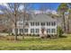 Charming two-story home with a manicured lawn, black shutters, and a welcoming front porch at 106 Legault Dr, Cary, NC 27513