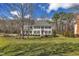 Beautiful two-story home with black shutters, mature trees, and a well-maintained front lawn at 106 Legault Dr, Cary, NC 27513