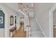 Spacious foyer with hardwood floors, staircase, and view into the dining room at 106 Legault Dr, Cary, NC 27513