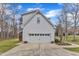 Detached two-car garage with white doors and additional storage space at 106 Legault Dr, Cary, NC 27513