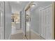 Bright hallway with closet and doorway leading to light-filled main bathroom with dual vanity at 106 Legault Dr, Cary, NC 27513
