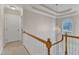 Bright hallway featuring a modern chandelier, white railing staircase, and natural light at 106 Legault Dr, Cary, NC 27513
