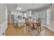 Bright eat-in kitchen with white cabinets, stainless steel appliances, and breakfast nook with large windows at 106 Legault Dr, Cary, NC 27513
