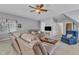 Spacious living room featuring neutral walls, a ceiling fan, and a comfortable seating area with a large TV at 106 Legault Dr, Cary, NC 27513