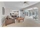 Inviting living room with neutral walls, plush carpeting, a ceiling fan, and views of the kitchen and sunroom at 106 Legault Dr, Cary, NC 27513