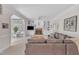 Spacious living room showcasing a brick fireplace, custom built-ins, and an open layout leading to the sunroom at 106 Legault Dr, Cary, NC 27513
