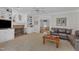 Living room featuring a brick fireplace, built-in shelves, and comfortable seating with a view to the kitchen at 106 Legault Dr, Cary, NC 27513