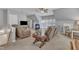 Open living room with dormer window, featuring a ceiling fan and comfortable reclining seating at 106 Legault Dr, Cary, NC 27513