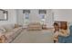 Cozy living room with floral sofas, natural light from windows, and hardwood flooring at 106 Legault Dr, Cary, NC 27513
