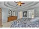 Inviting main bedroom with a decorative tray ceiling and dresser with dual mirrors at 106 Legault Dr, Cary, NC 27513