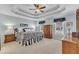 Spacious main bedroom featuring trey ceiling, neutral carpet, and ample natural light from windows at 106 Legault Dr, Cary, NC 27513