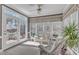 Bright sunroom features ample windows, white wicker furniture, a ceiling fan, and access to a patio at 106 Legault Dr, Cary, NC 27513