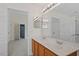 Hall bathroom with a double sink vanity and shower over the tub at 110 Darley Dale Loop, Apex, NC 27502