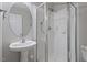 Clean and bright bathroom featuring a glass-enclosed shower, a pedestal sink, and white tile at 110 Darley Dale Loop, Apex, NC 27502