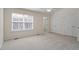 Sunlit bedroom with neutral carpet, white trim, a ceiling fan, and double closets at 110 Darley Dale Loop, Apex, NC 27502