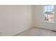 Bright bedroom with neutral carpet, white trim and a window letting in lots of natural light at 110 Darley Dale Loop, Apex, NC 27502