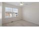 Bright bedroom with neutral carpet, white trim, a ceiling fan and a window at 110 Darley Dale Loop, Apex, NC 27502