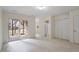 Bright bedroom with neutral carpet, sliding glass doors to the outdoors, and a full bathroom entrance at 110 Darley Dale Loop, Apex, NC 27502