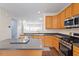 Bright kitchen featuring stainless steel appliances, an island, and wood cabinetry at 110 Darley Dale Loop, Apex, NC 27502
