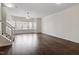 Spacious living room featuring hardwood floors, ceiling fan, and bright natural light from the window at 110 Darley Dale Loop, Apex, NC 27502
