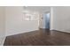 Spacious living room featuring hardwood floors and view into the kitchen and staircase at 110 Darley Dale Loop, Apex, NC 27502