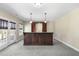 Spacious basement featuring a wet bar with wine rack and convenient access to the outdoors at 1104 Fanning Dr, Wake Forest, NC 27587