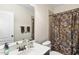 Bathroom with framed mirror, single sink vanity, decorative shower curtain, and tile accents at 1104 Fanning Dr, Wake Forest, NC 27587