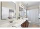 Bright bathroom features double vanity with modern fixtures, white countertop, and framed mirrors at 1104 Fanning Dr, Wake Forest, NC 27587