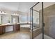 Bright bathroom featuring double sinks, a large tub, a glass-enclosed shower, and tile flooring at 1104 Fanning Dr, Wake Forest, NC 27587