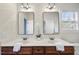 Bright bathroom features double vanity with modern fixtures and decorative mirrors with a flower accent at 1104 Fanning Dr, Wake Forest, NC 27587
