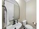 Compact half-bathroom features a modern sink, a sleek black faucet, and a space-saving design at 1104 Fanning Dr, Wake Forest, NC 27587