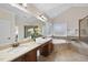 Bathroom featuring double sinks, a large mirror, a soaking tub, and a glass shower at 1104 Fanning Dr, Wake Forest, NC 27587