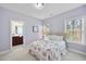 Bright bedroom featuring carpet, a double window, and an ensuite bathroom at 1104 Fanning Dr, Wake Forest, NC 27587