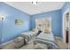 Charming bedroom featuring bright blue walls, twin beds, and a sunlit window at 1104 Fanning Dr, Wake Forest, NC 27587