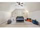Inviting bonus room with vaulted ceilings, plush seating, and natural light at 1104 Fanning Dr, Wake Forest, NC 27587